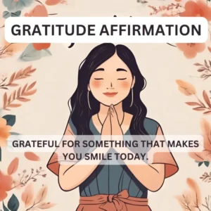 Illustration of a smiling woman with closed eyes, hands in a prayer gesture, surrounded by floral elements. The text "Gratitude Affirmation" appears above her, and below it reads "Grateful for something that makes you smile today."