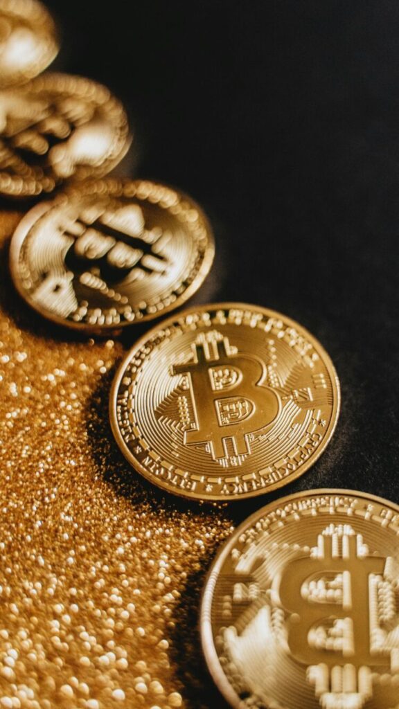 A Phone wallpaper featuring bitcoins with golden background symbolizing Financial abundance.