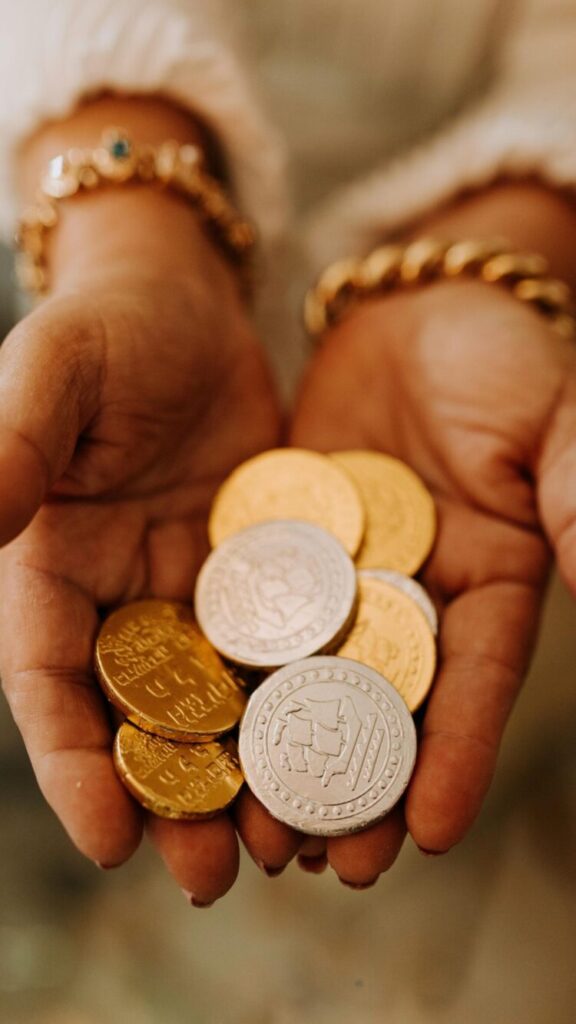 A Phone wallpaper featuring silver and golden coins symbolizing Financial abundance.