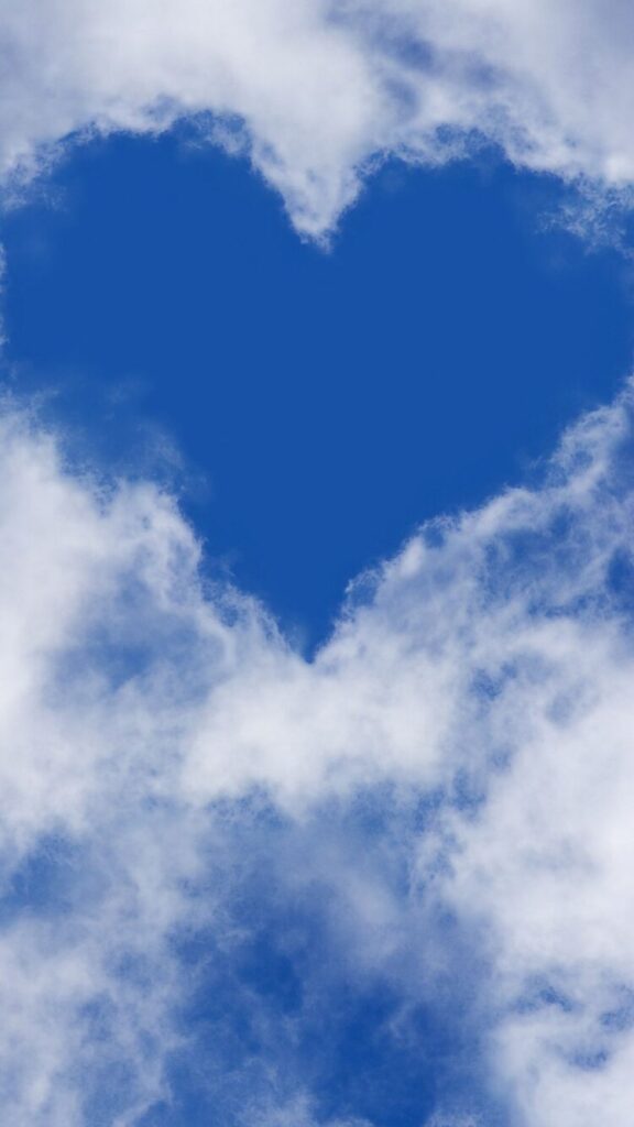 Blue sky white heart shape with clouds, designed as a Love and Relationships Manifestation Wallpaper for Phone.